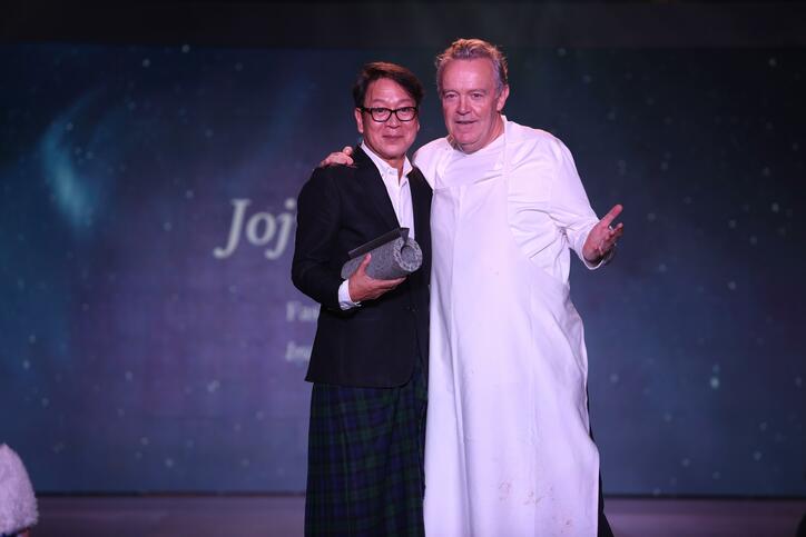 Celebrity chef Alain Passard hands award to fashion designer Jojie Lloren.